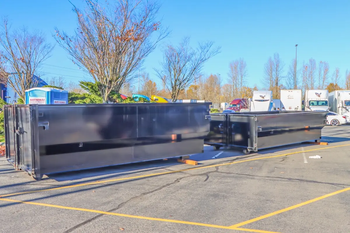 Professional dumpster rental service with roll-off container on residential driveway in Dunn Loring